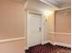 Hallway with a cream door and patterned walls, leading to a stylish and inviting space at 7593 Gathering Dr # 203, Reunion, FL 34747