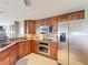 Bright kitchen with stainless steel appliances, granite countertops and tile backsplash at 7593 Gathering Dr # 203, Reunion, FL 34747