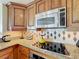 Modern kitchen with stainless steel appliances, tile backsplash, and sleek countertops at 7593 Gathering Dr # 203, Reunion, FL 34747