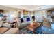Inviting living room with plush sofas, stylish coffee table, and a view of the kitchen area at 7593 Gathering Dr # 203, Reunion, FL 34747