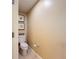 Small powder room features a toilet and picture decorations at 7593 Gathering Dr # 203, Reunion, FL 34747