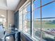 A bright, expansive window view of a golf course and nearby houses from a well-lit room at 7593 Gathering Dr # 203, Reunion, FL 34747