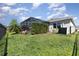 Well-maintained backyard featuring lush greenery, a privacy fence, and a screened in lanai at 7838 Penrose Pl, Wildwood, FL 34785