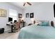 Light filled bedroom with a dedicated workspace and calming decor at 7838 Penrose Pl, Wildwood, FL 34785
