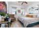 Comfortable bedroom is styled with an accent chair, a large bed, wood-look tile flooring, and plenty of light at 7838 Penrose Pl, Wildwood, FL 34785