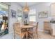 Cozy dining area with a round wooden table, wicker pendant lighting, and sliding glass doors to the patio at 7838 Penrose Pl, Wildwood, FL 34785