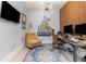 Well-lit home office features a large desk, a comfortable chair, a flat-screen TV, and modern decor at 7838 Penrose Pl, Wildwood, FL 34785
