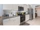 Well-equipped kitchen features granite countertops, stainless steel appliances, white cabinets, and ample storage space at 7838 Penrose Pl, Wildwood, FL 34785