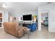 Open-concept living room showcasing modern furniture, tile flooring, and seamless flow to other areas at 7838 Penrose Pl, Wildwood, FL 34785