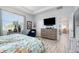 Comfortable main bedroom features a tray ceiling, stylish decor, a large window, and plenty of space at 7838 Penrose Pl, Wildwood, FL 34785