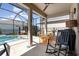 Spacious screened patio offering both dining and relaxation spaces with a view of the pool at 7838 Penrose Pl, Wildwood, FL 34785