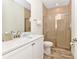 Clean bathroom featuring a sink, quartz countertop, and glass enclosed shower at 8199 Coconut Pl, Kissimmee, FL 34747
