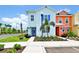 Inviting two-story home featuring a cheerful light blue exterior and lush landscaping at 8199 Coconut Pl, Kissimmee, FL 34747