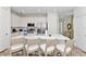 Modern kitchen with white cabinetry, stainless steel appliances, and spacious island at 8199 Coconut Pl, Kissimmee, FL 34747