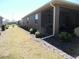 Backyard showcasing lush landscaping, a covered lanai, and well-maintained grass at 8824 Sw 104Th Cir, Ocala, FL 34481