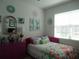 Stylish bedroom features a colorful bedspread, decor and natural light creating a cheerful, inviting atmosphere at 8824 Sw 104Th Cir, Ocala, FL 34481
