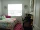 Functional bedroom space with a desk, chair, and bright light perfect for school or work at 8824 Sw 104Th Cir, Ocala, FL 34481