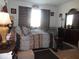 Comfortable bedroom featuring a queen bed, matching furniture, and natural light creating a cozy retreat at 8824 Sw 104Th Cir, Ocala, FL 34481
