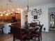 Elegant dining room with a decorative chandelier, round table, and kitchen access at 8824 Sw 104Th Cir, Ocala, FL 34481
