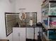 Practical laundry room with patterned backsplash, sink, and storage shelving for convenience at 8824 Sw 104Th Cir, Ocala, FL 34481