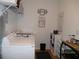 Functional laundry room with a washer, dryer, shelving and ample storage space at 8824 Sw 104Th Cir, Ocala, FL 34481