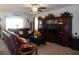 Comfortable living room with plush seating, a ceiling fan, and a decorative entertainment center at 8824 Sw 104Th Cir, Ocala, FL 34481