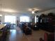 Spacious living room with a ceiling fan, comfortable seating, and large windows at 8824 Sw 104Th Cir, Ocala, FL 34481