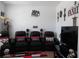 Comfortable home theater featuring reclining seats, and a large screen TV for an immersive movie experience at 8824 Sw 104Th Cir, Ocala, FL 34481