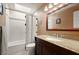 Well lit bathroom with a shower and bathtub combo, skylight, granite countertops, and dark wood cabinets at 437 Wilmington Cir, Oviedo, FL 32765