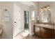 Bathroom featuring a walk-in shower with a glass door, a vanity with a sink, and a towel rack at 437 Wilmington Cir, Oviedo, FL 32765
