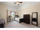 Bright bedroom featuring neutral walls, carpet flooring, a ceiling fan, and dark wood furniture at 437 Wilmington Cir, Oviedo, FL 32765