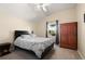 Bedroom with a patterned bed, a window with curtains, and a wardrobe at 437 Wilmington Cir, Oviedo, FL 32765