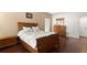 Bedroom with a wooden bed frame, hardwood floors, and a large window at 437 Wilmington Cir, Oviedo, FL 32765