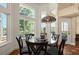 Dining area with pool view, featuring large windows, and round table for six at 437 Wilmington Cir, Oviedo, FL 32765