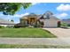 Charming two-story brick home with a manicured lawn and beautiful landscaping creating a welcoming curb appeal at 437 Wilmington Cir, Oviedo, FL 32765