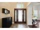 Grand foyer featuring a decorative front door with side panels and a high ceiling with natural light and tile flooring at 437 Wilmington Cir, Oviedo, FL 32765