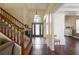 Bright foyer with stairs and dark wood floors, leading to a front door at 437 Wilmington Cir, Oviedo, FL 32765