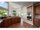 Bright kitchen with stainless steel appliances, granite countertops, and terracotta-colored tile flooring at 437 Wilmington Cir, Oviedo, FL 32765