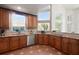 Kitchen with stainless steel appliances, terracotta-colored tile flooring, and granite countertops at 437 Wilmington Cir, Oviedo, FL 32765