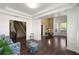 Spacious living room with dark hardwood floors and an open layout leading to the entryway and staircase at 437 Wilmington Cir, Oviedo, FL 32765