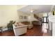 Living room with hardwood floors, ceiling fan, and staircase to the second floor at 437 Wilmington Cir, Oviedo, FL 32765