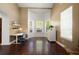 A well-lit office with hardwood floors, bright walls, lots of natural light, and a dedicated workspace at 437 Wilmington Cir, Oviedo, FL 32765