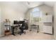 Office with a large window, desk, chair, and storage cabinets at 437 Wilmington Cir, Oviedo, FL 32765