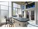 Enclosed patio area featuring an outdoor kitchen with a grill, bar, and tiled countertops at 437 Wilmington Cir, Oviedo, FL 32765