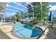 Beautiful enclosed pool with spa, blue tile, and well-maintained landscaping for a luxurious backyard experience at 437 Wilmington Cir, Oviedo, FL 32765