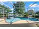 Stunning screened in pool area with a spa, lounge area, and views of a lake at 437 Wilmington Cir, Oviedo, FL 32765