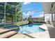 Enclosed pool with a built-in spa and poolside seating, perfect for relaxation and enjoying the beautiful outdoors at 437 Wilmington Cir, Oviedo, FL 32765