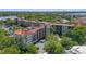 Gorgeous aerial view of a residential complex featuring a pool, parking, and lovely landscaping with a lakeside view at 100 S Interlachen Ave # 503, Winter Park, FL 32789