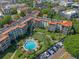 Beautiful aerial view of a condominium community featuring a pool, putting green, and parking at 100 S Interlachen Ave # 503, Winter Park, FL 32789