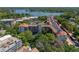 Captivating aerial view of a luxury building featuring red tile roofing, lush landscaping, and access to a tranquil lake at 100 S Interlachen Ave # 503, Winter Park, FL 32789